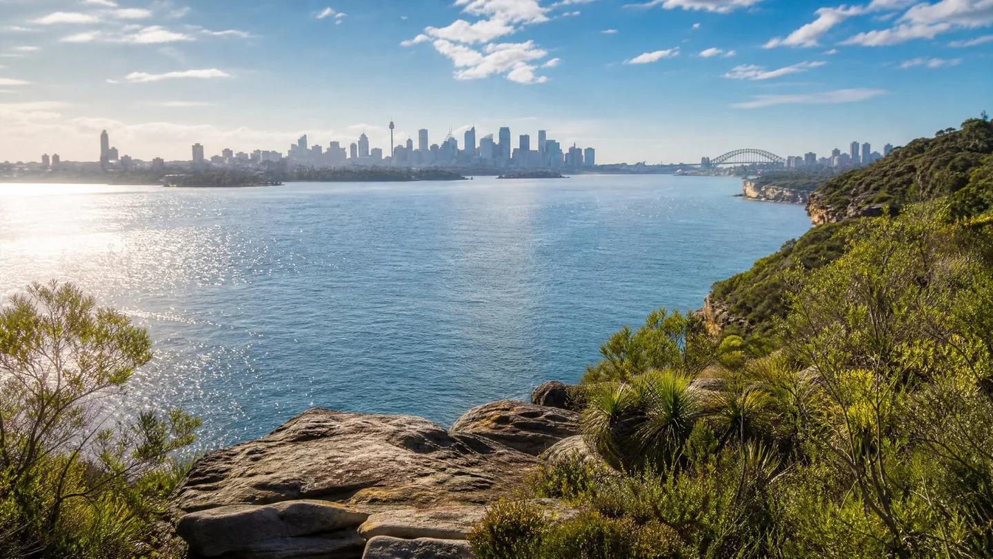 Cover image for The shimmering waterway where urban grandeur meets ancient coastal wilderness