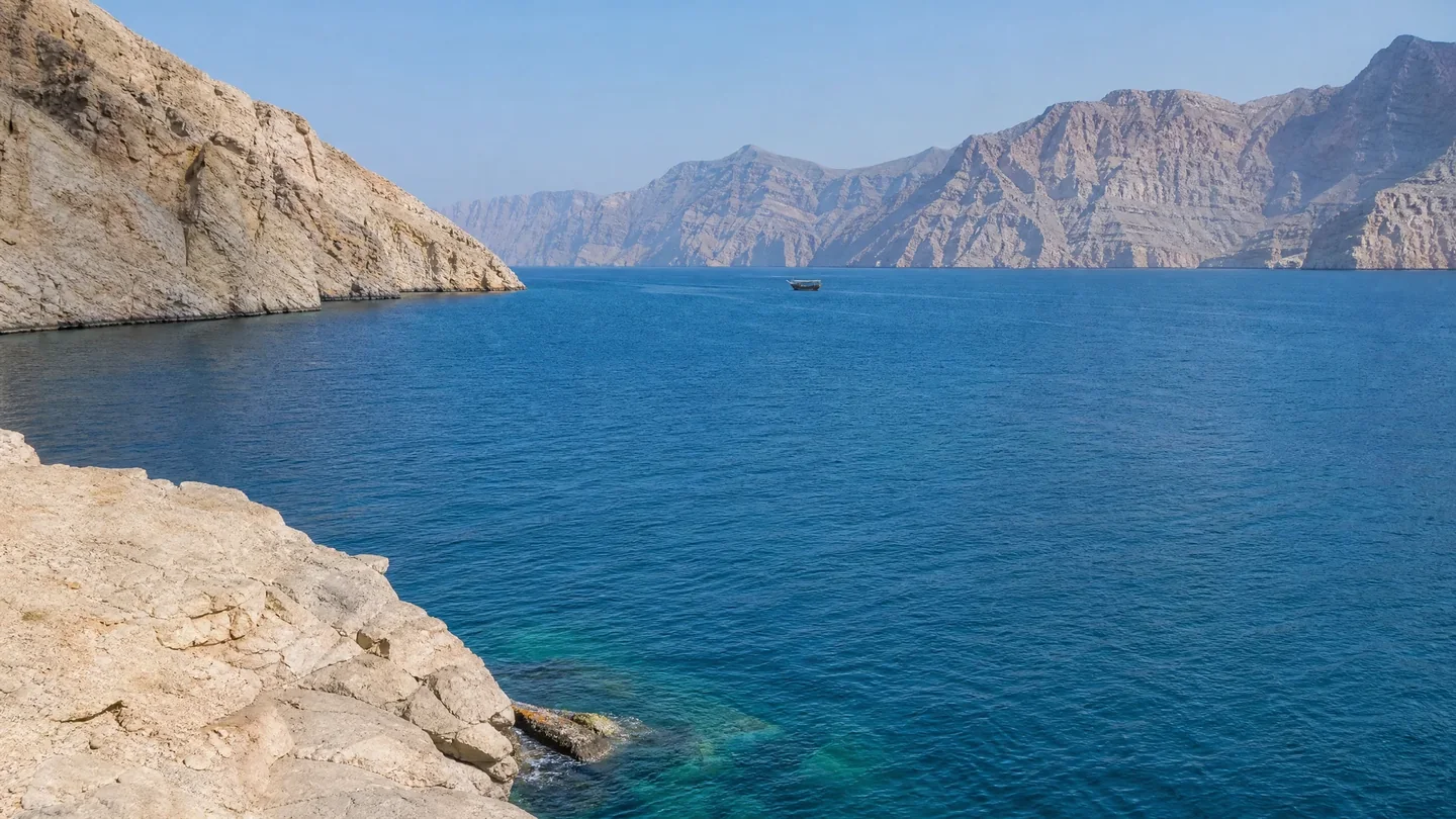 Cover image for The limestone cathedrals of Musandam rise where the desert meets the deep Arabian sea.