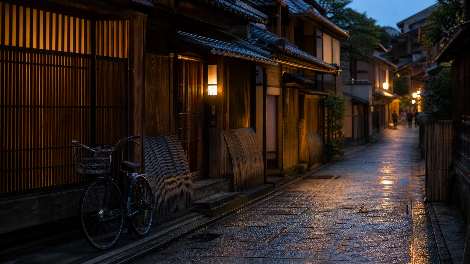 A stone-paved Higashiyama lane at blue hour with timber facades, a bicycle, and warm lantern light.